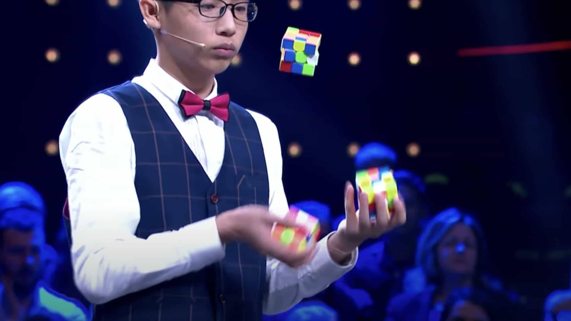 guy solves 3 runix cubes while juggling guy solves 3 runix cubes while juggling
